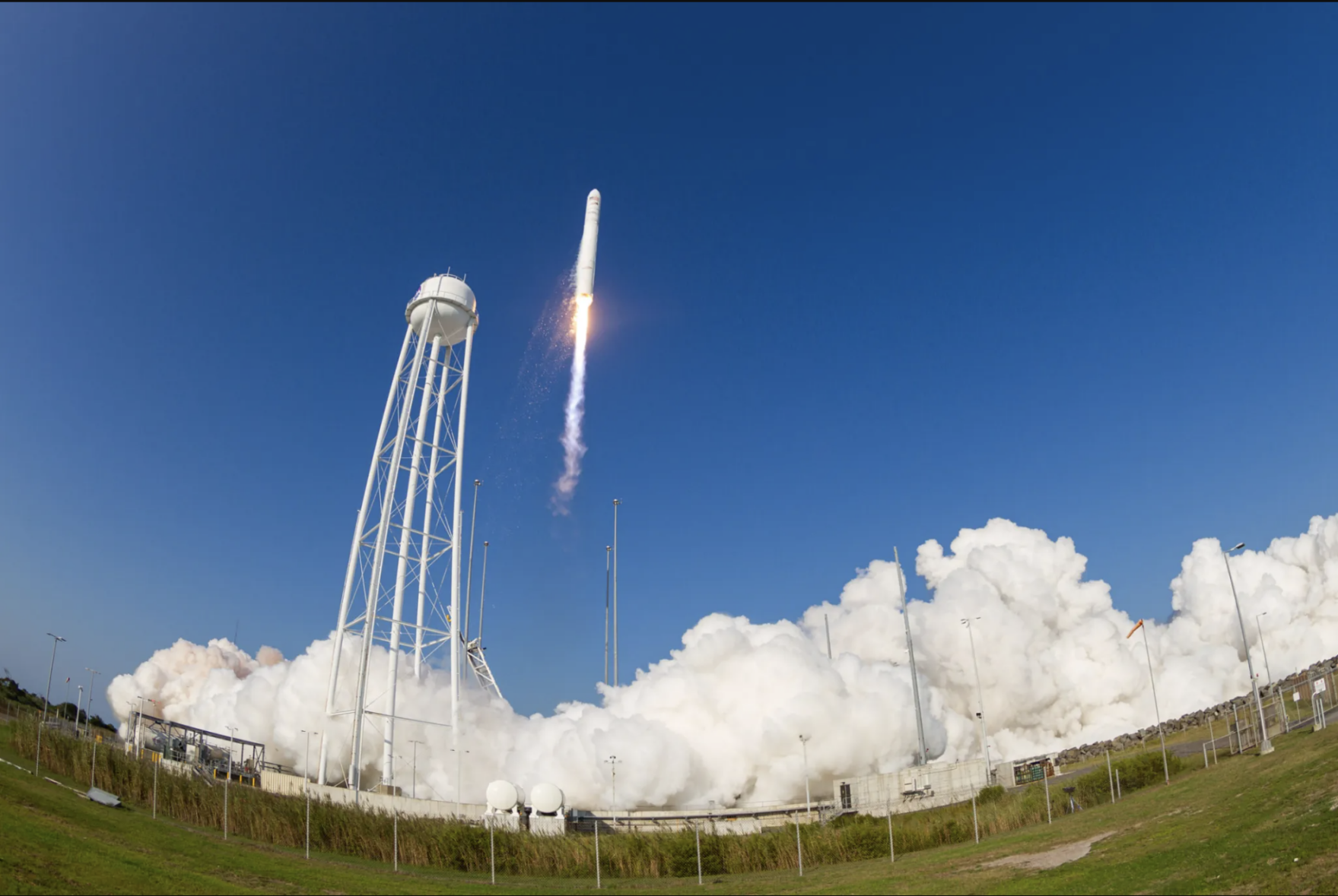 Rocket launching into the air over clouds in Wallops Island